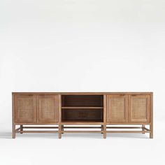 the sideboard is made out of wood and has rattan panels on it's sides