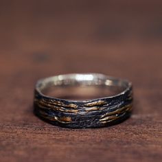 A simple oxidized silver band, with a raw surface and thin gold leaf stripes, burnished on top of the silver, creates a stunning look of 24K gold popping up from the dark silver unrestrained, showing a different texture each time. With its exceptional craftsmanship and unique appeal, this ring is a remarkable and meaningful representation of your commitment. * Material: Silver & Gold * All of our jewelry is handmade, so there might be a slight difference between each piece * If you can't find th Keum Boo Jewelry, Keum Boo, Rough Texture, Different Textures, Oxidized Silver, Silver Band, Gold Leaf, Wedding Rings Engagement, Wedding Engagement