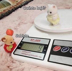 a toy mouse sitting on top of a scale