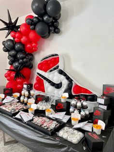 a star wars themed birthday party with balloons and snacks on a table in front of the balloon wall