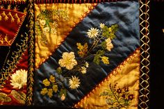 two pieces of cloth with flowers and leaves on them, one is blue and the other is yellow