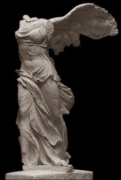 a statue of an angel with wings on top of a white marble block in front of a black background