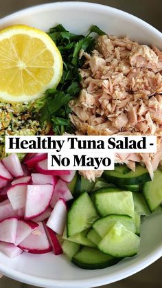 a white bowl filled with cucumbers, radishes and other food items