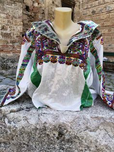 This is a lovely and unique, handmade vintage blouse. It is made of linen and is decorated with hand embroidery and beads. Every single detail and decor is handmade. Many work hours spent in manufacturing this blouse. It was made in the 1960's or 1970's. it is kept in a very good condition, without damages. Eye-catching design and pattern, unique blouse made by the women by their own who lived in the village of Labunista, near the Ohrid Lake. It is a light weight, smooth blouse made of linen. Lo Traditional Long Sleeve Linen Tops, Traditional White Linen Blouse, Green Linen Bohemian Blouse, Green Linen Bohemian Top, Bohemian Green Top With Intricate Embroidery, Green Bohemian Top With Intricate Embroidery, Bohemian Green Tops With Intricate Embroidery, Green Bohemian Tops With Intricate Embroidery, Green Bohemian Linen Top