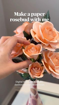 a person is holding some fake flowers in a vase with leaves on the top and bottom