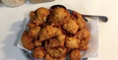 some fried food is on a plate with spoons