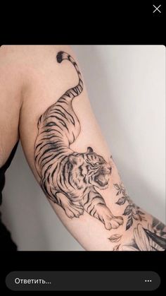 a man with a tiger tattoo on his arm