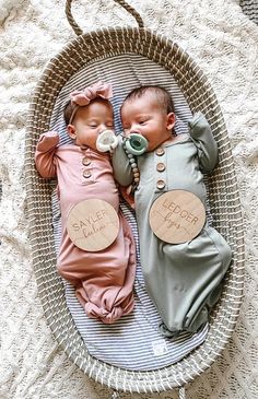 two baby babies are sleeping in a basket