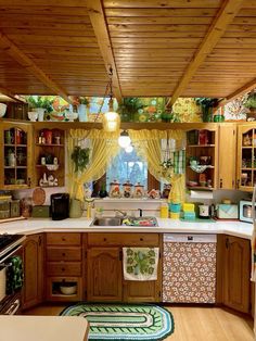 a kitchen with wooden cabinets and yellow curtains