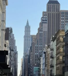 an empty city street with tall buildings in the backgroung and cars driving down it