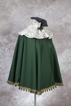 This cape would be suitable for 1890th dresses. This cape is made in wool fabric and has support boning for the collar. Custom sized to your measurements. Please send me bust, waist, hip and length measurements after the order has been completed. Can be shipped in other countries, please feel free to ask. There are a lot of different historical dresses and costumes in my shop, feel free to visit under https://midinettecostuming.etsy.com ℹ Herstellerangaben gemäß GPSR: MidinetteCostuming, Inna Ti Elegant Fitted Cape For Costume Party, 1890 Dress, Wizard Cloak, Victorian Cape, Green Cape, Shoulder Cape, Body Outfit, Historical Dresses, Women's Costumes