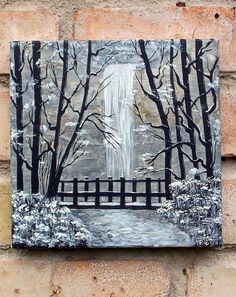 a painting on the side of a brick wall with trees and a waterfall in the background