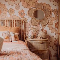 a child's bedroom with floral wallpaper and rattan bedspread, wicker furniture and teddy bear