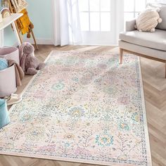 a living room area with a rug, chair and teddy bear