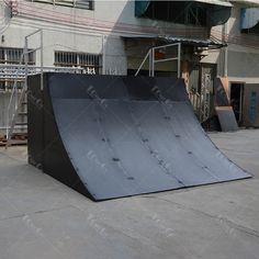 a skateboard ramp in front of a building