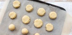 doughnuts on a baking sheet ready to go into the oven for making cookies