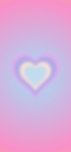 a blurry image of a heart in the middle of pink, blue and yellow