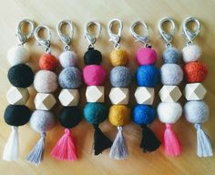 several different colored pom - poms are arranged in rows on a wooden surface