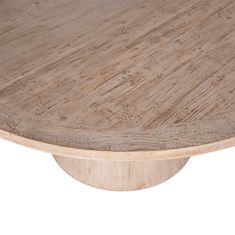 a round wooden table with an oval base