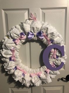 a wreath made out of diapers with the letter d on it's front door