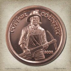 an image of a bronze medal with a man holding a hammer and wearing a hat