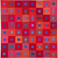 an orange and red quilt with squares on it