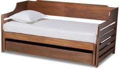 a small wooden bed with white sheets on it's bottom and side rails, against a white background