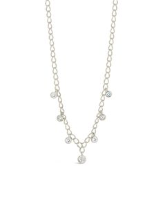 Add a touch of sparkle and a dash of pizzazz to any outfit with this shimmering Sydney Necklace! With a delicate chain and CZ charms, this dainty piece is sure to turn heads - no matter where you go. Materials: 14K gold or rhodium plated brass, cubic zirconia Features: Measures 16" with 2" extender, 0.25"-0.3" charms, 3-4mm CZ stones, 3.5mm chain width, Lead & Nickel free, lobster clasp Silver Diamond Charm Necklace With Delicate Chain, Delicate Cubic Zirconia Charm Necklace With Adjustable Chain, Dainty Cubic Zirconia Cable Chain Necklace, Dainty Cubic Zirconia Chain Necklace, Delicate Diamond Charm Necklace With Adjustable Chain, Silver Chain Dangle Charm Necklaces, Dainty Diamond Chain Necklace With Adjustable Chain, Dainty Cubic Zirconia Chain Necklace With Delicate Chain, Dainty Cubic Zirconia Delicate Chain Necklace