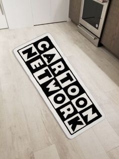 a kitchen floor mat that has the words qn and arrow on it in black