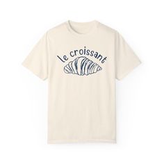 "Le Croissant" Graphic Tee - Serve up Parisian vibes with a side of chic in this cute, French café-inspired essential! We use professional quality DGT printing on all our apparel. Direct-to-garment, or DTG, is a high quality printing method that sprays ink directly onto the garment so there is no peeling or cracking. This fabulous graphic will be printed on a Comfort Colors Unisex T-Shirt. Please refer to the size charts in the images for the best fit.  Estimated Production Time: 1-5 days Estimated Shipping Time: 2-5 days 100% cotton shirt  Machine wash: cold  Non-chlorine: bleach as needed Tumble dry: low heat Iron, steam or dry: medium heat Do not dry clean Short Sleeve Screen Print Tops For Brunch, Short Sleeve T-shirt With Screen Print For Brunch, Short Sleeve Screen Print T-shirt For Brunch, Cotton T-shirt With Letter Print For Brunch, Graphic Tee With Letter Print For Brunch, Graphic Tee With Screen Print For Brunch, Casual Screen Print T-shirt For Brunch, Short Sleeve Cotton T-shirt For Brunch, Crew Neck Cotton Shirt For Brunch