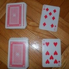 four playing cards laid out on the floor