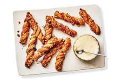 chicken wings on a cutting board with dipping sauce