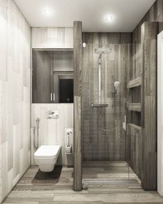 a bathroom with a toilet, sink and shower stall in wood paneled walling