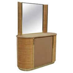 a mirror sitting on top of a wooden cabinet next to a shelf with a mirror