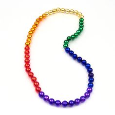 a multicolored beaded necklace on a white background