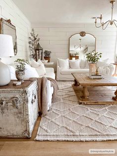 a living room filled with furniture and a large mirror on the wall above it's coffee table