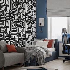 a living room with a couch, chair and wallpaper