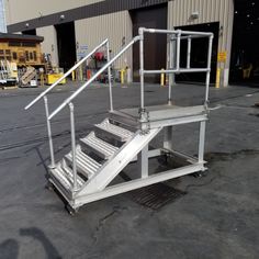 a set of stairs sitting in front of a building with metal railings and hand rails