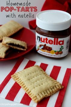 homemade pop tarts with nutella on a red and white striped napkin next to a jar of nutella