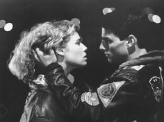 an old black and white photo of two people in leather jackets looking into each other's eyes