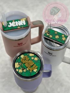 two coffee mugs sitting next to each other on top of a white tablecloth