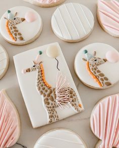 decorated cookies are arranged in the shape of giraffes and seashells