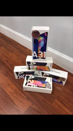 three boxes are stacked on top of each other in the middle of a floor with wood floors