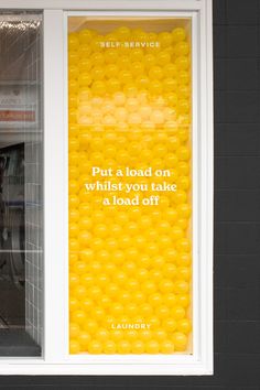 an advertisement on the side of a store window that says, put a load on which you take a load off