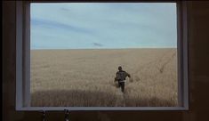 a man running through a field in the middle of nowhere