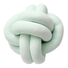 the knot pillow in mint green is made from soft, plush material and has been folded into