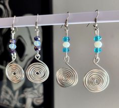 These unique earrings would be a great gift, and are perfect for multiple occasions!  Made with Silver plated Copper wire Spiral Wire Jewelry, Handmade Swirl Earrings For Gifts, Handmade Swirl Earrings As Gift, Adjustable Spiral Earrings For Gifts, Spiral Silver-plated Wire Earrings, Swirl Shaped Metal Earrings For Gift, Unique Nickel-free Wire Earrings, Swirl Shaped Metal Earrings As Gift, Hypoallergenic Spiral Metal Earrings