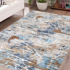 an area rug with blue, brown and white designs on it in a living room