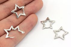 three small silver stars are shown in the palm