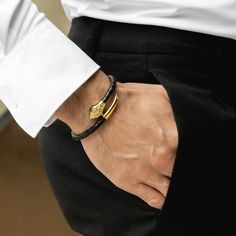 "\"The bracelet features a golden snake charm intricately designed and expertly crafted, symbolizing power, transformation, and wisdom.  The combination of the luxurious golden snake and the supple black python leather creates a striking contrast, making this bracelet a true statement piece. 🎁 PERFECT GIFTS FOR MEN - Genuine energy protection jewelry is a great gift for anyone interested in spiritual protection symbols or eye-catching bracelets. 📏 ADJUSTABLE CORD BRACELETS FOR MEN - This ultra-wearable multi-purpose bracelet is wrapped and can comfortably fit wrists sizes from 7.5 inch to 8.3 inch (19 cm to 21 cm). 🏷️ DETAILS: * Handmade Item with Unique Design * Material: Lizard Leather, Stainless Steel with Zircon Diamond * Color: Black * Fastening: Magnetic closure * Finish: Gold pla Luxury Leather Bangle Bracelet Gift, Luxury Snake Shape Bracelet For Gift, Gold Leather Jubilee Bracelet, Serpent Jewelry Men, Luxury Snake-shaped Bracelets As Gift, Adjustable Luxury Snake Bracelets, Luxury Snake-shaped Bracelet As Gift, Luxury Adjustable Snake Bracelets, Adjustable Luxury Snake Bracelet